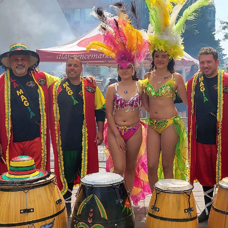 An image of male and female Candombe characters in multi colored bright costumes