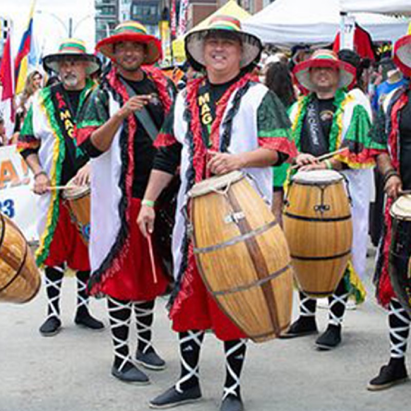 An image of Tamborilero Candombe drummers in full costume