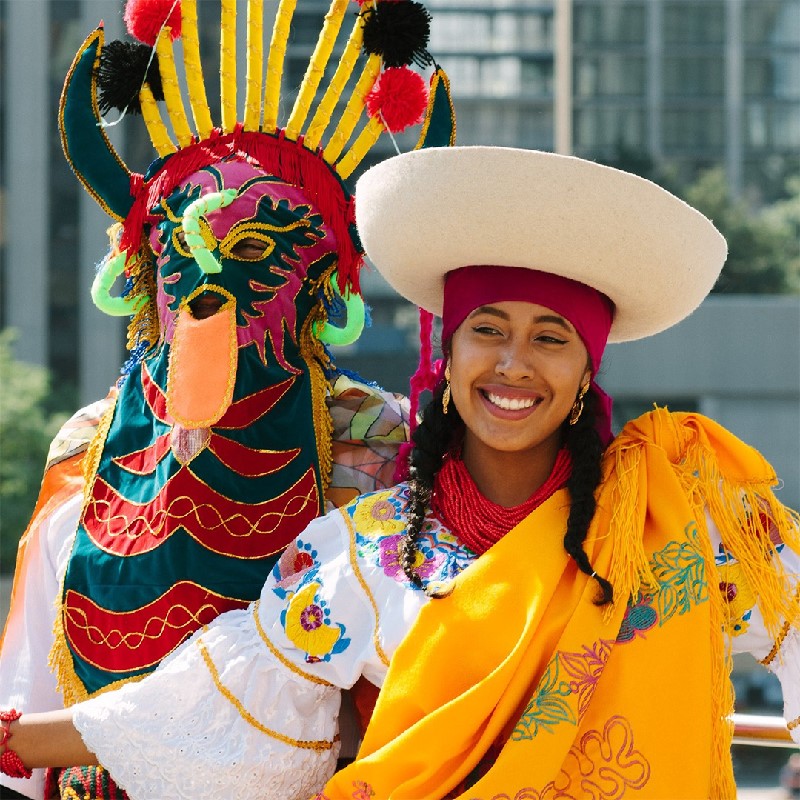 A photo of Inti Raymi dancers in colorful costumes