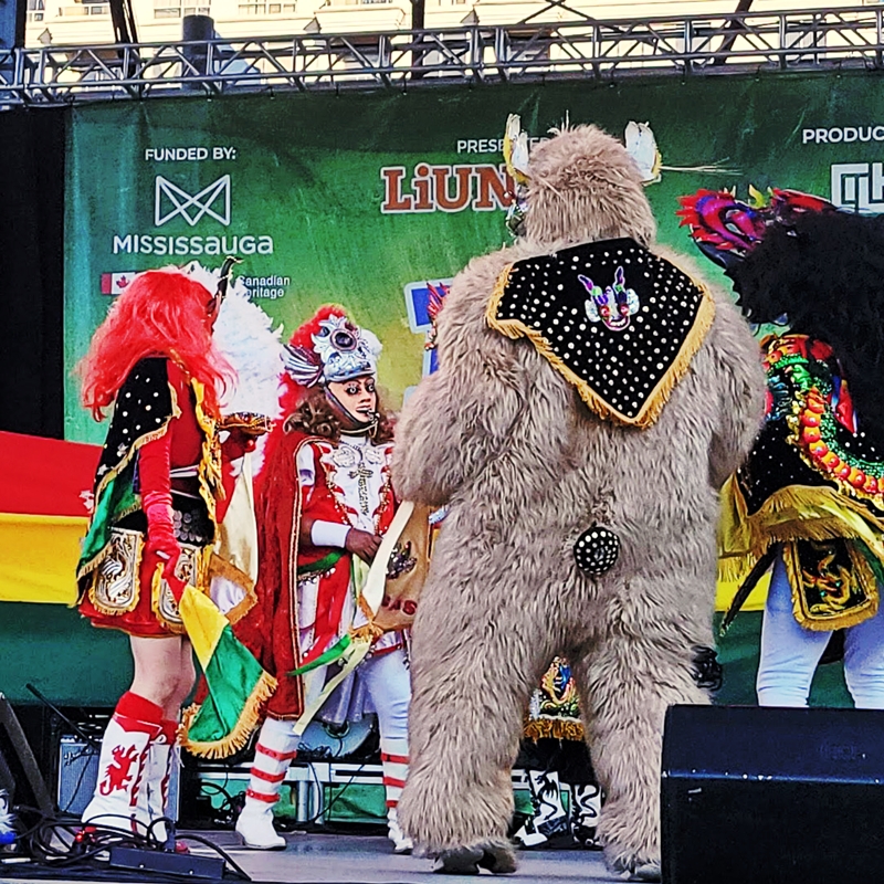 People standing side by side representing the different characters of the Diablada