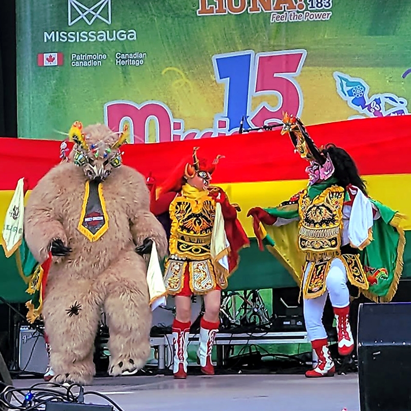 People standing side by side representing the different characters of the Diablada